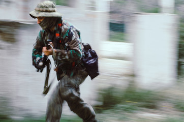 Blurry on motion Special forces soldier holding rifle  aim and run