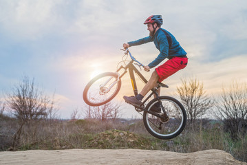Fototapeta na wymiar Biker on a mountain bike performing a jump. Active lifestyle.