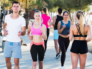 People jogging on city seafront