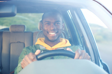 happy african american man driving car