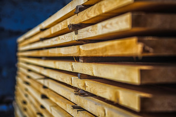Wooden planks. Beams. Air-drying timber stack. Wood air drying (seasoning lumber or wood seasoning). Timber. Lumber. Close-up.