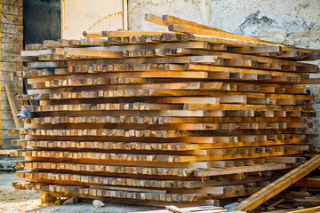 Wooden planks. Beams. Air-drying timber stack. Wood air drying (seasoning lumber or wood seasoning). Timber. Lumber. Close-up.
