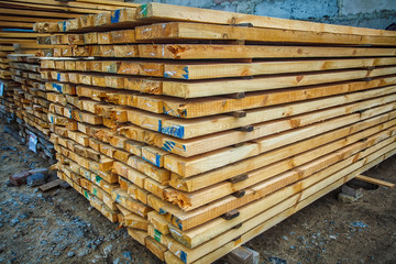 Wooden planks. Beams. Air-drying timber stack. Wood air drying (seasoning lumber or wood seasoning). Timber. Lumber.