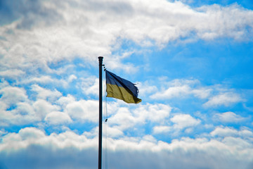 Flag of Ukraine. against blue sky, flag installed on flagpole in Kyiv