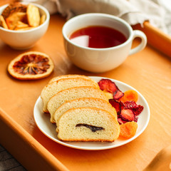 cornflakes, coffee, bread, butter, eggs, jam and other ingredients for breakfast on a dark background. Top view with copy space
