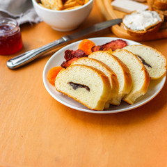 cornflakes, coffee, bread, butter, eggs, jam and other ingredients for breakfast on a dark background. Top view with copy space