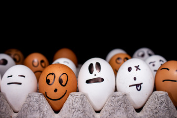 Eggs with funny expressions simulating human faces. Concept of ethnic diversity and moods.