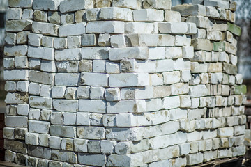 Pallet of paving slab closeup on a construction site in sunny day. Paving slabs in the packaging at the construction site. Brick. Close-up.