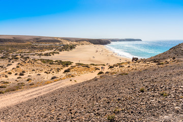Unique panoramic view of famous Playa Blanca Papagayo beach jagged volcanic lava rock Atlantic ocean shoreline of Lanzarote, Canary Islands, Spain. Travel vacation concept.