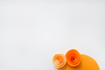 Colorful handmade paper flowers on light coloured background for invitation and wedding