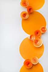 Colorful handmade paper flowers on light coloured background for invitation and wedding