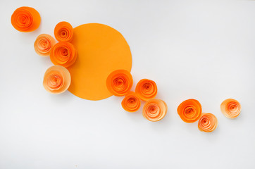 Colorful handmade paper flowers on light coloured background for invitation and wedding