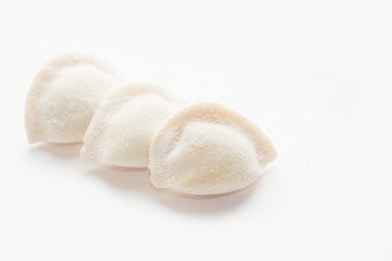 three frozen dumplings on a white background. Isolated Dumplings