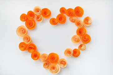 Colorful handmade paper flowers on light coloured background for invitation and wedding