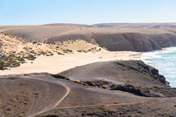 Unique panoramic view of famous Playa Blanca Papagayo beach jagged volcanic lava rock Atlantic ocean shoreline of Lanzarote, Canary Islands, Spain. Travel vacation concept.