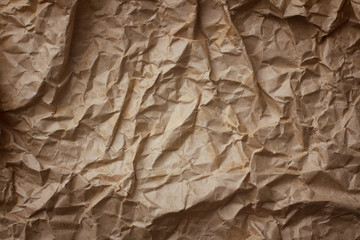 Craft brown crumpled paper background texture with vignette shadow.