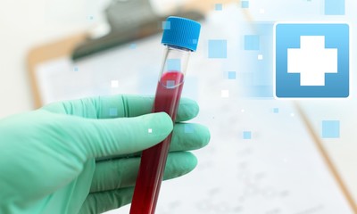 Male hand holding science laboratory test tube with blood