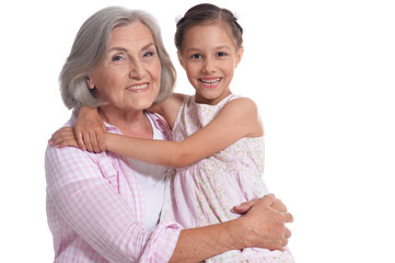 Portrait of grandmother hugging with her cute granddaughter