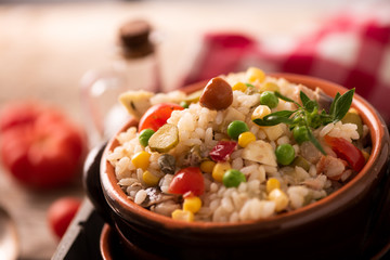 Rice salad in a bowl on wooded table