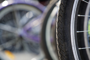 Bicycle wheel in a row close-up wheel detail, bicycle spoke.