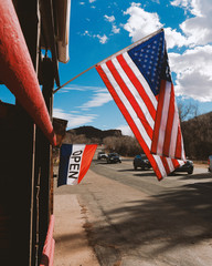 american flag in front of modern building