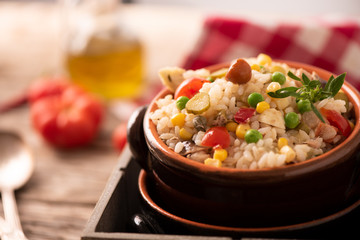 Rice salad in a bowl on wooded table