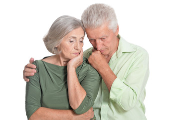 Portrait of sad senior couple on white background