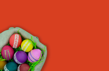 Basket with Easter eggs on a red background