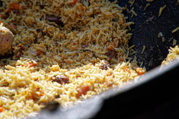 Fried rice with chicken, prepared and served in wok. Natural healthy food