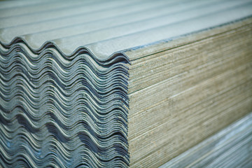 Asbestos roof. Asbestos cement roofing sheets, corrugated panels, stacked.