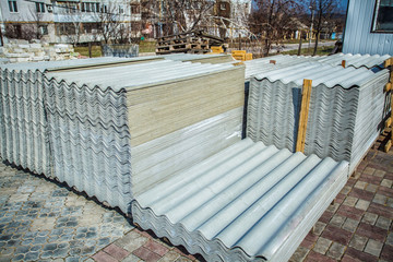 Asbestos roof. Asbestos cement roofing sheets, corrugated panels, stacked.