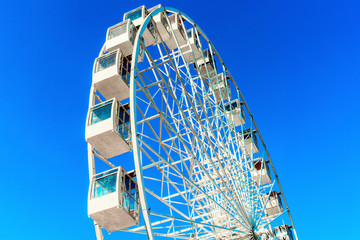 Ferris wheel on a background of blue sky