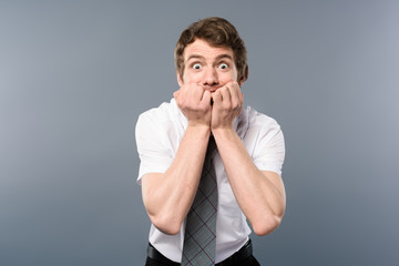 funny stressed and scared businessman on grey background