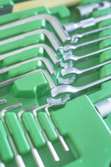 Set of tools for car repair in green box, close-up.