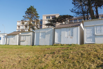 Fototapeta na wymiar White beach sheds at Ris beach in Douarnenez