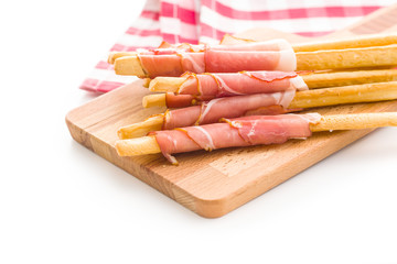 Parma ham prosciutto with grissini breadsticks.