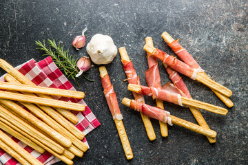 Parma ham prosciutto with grissini breadsticks.