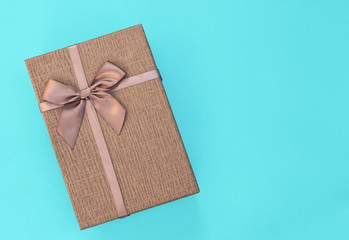 Grey gift package on a blue background. Copy space.