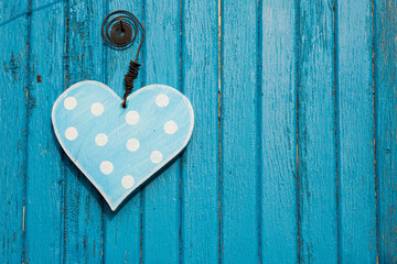 Blue heart on blue wooden background