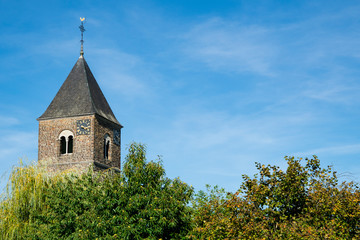Fototapeta premium Sint Pancratius Church in Mesch, The Netherlands. Blue sky, space for text