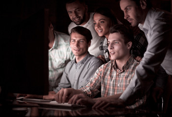 business team looks closely at the computer monitor