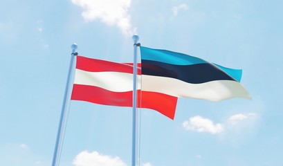 Austria and Estonia, two flags waving against blue sky. 3d image