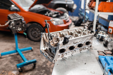 Selective focus. Engine Block on a repair stand with Piston and Connecting Rod of Automotive...