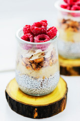 Chia pudding with raspberries, banana and coconut. Healthy superfood for breakfast