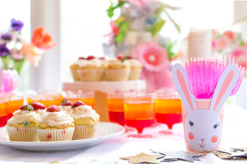Dessert table with cupcakes and flowers Easter party theme