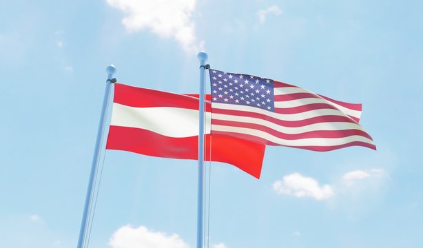 Austria and USA, two flags waving against blue sky. 3d image