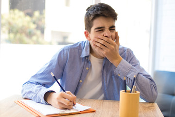 student yawning bored at the desk