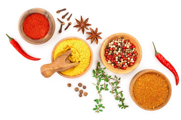 mix of spices in wooden bowl isolated on a white background with copy space for your text. Top view. Flat lay. Set or collection