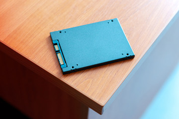 solid-state drive at wooden table. ssd for desktop or laptop upgrade hardware.