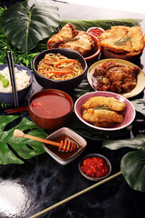 Assorted Chinese food set. Chinese noodles, fried rice, peking duck, dim sum, spring rolls. Famous Chinese cuisine dishes on table. Chinese restaurant